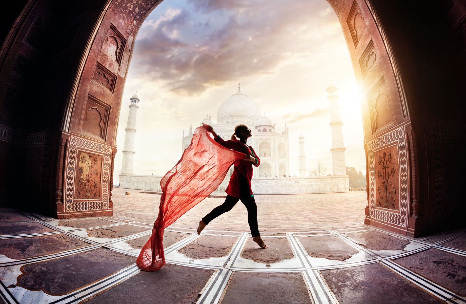 Mujer con bufanda roja bailando cerca del Taj Mahal en Agra, Uttar Pradesh, India